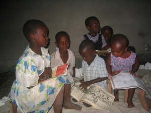 Kids at the Baobab House reading some of the books they have now.