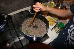 Wescott mixing in Oregano into crumbled sausage and ground beef