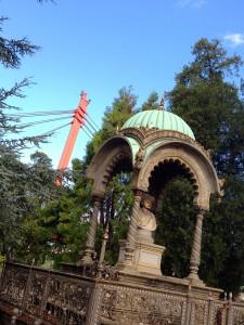 Cool monument to someone really old and cool with a super-cool, modern bridge in the background